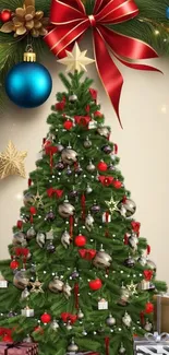 Festive Christmas tree with red ribbon and ornaments.