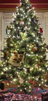 Festive Christmas tree with lights and gifts as a mobile wallpaper.