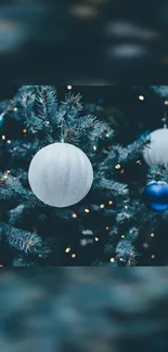 Festive Christmas tree with blue and white ornaments and twinkling lights.