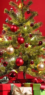 Vibrant Christmas tree with red ornaments and gift boxes on a vivid red backdrop.