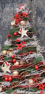 Festive Christmas tree with red stars and pine cones on mobile wallpaper.