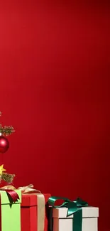 Christmas tree with presents on red background wallpaper.