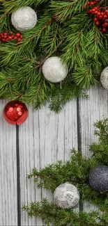 Festive Christmas wallpaper with pine branches and colorful ornaments.