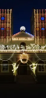 Church illuminated with festive lights at night.