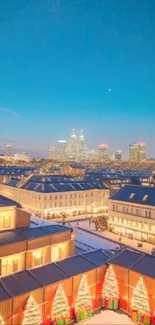 Festive city skyline illuminated at night with Christmas lights and decorations.