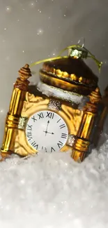 Gold clock ornament on snowy background, festive theme.