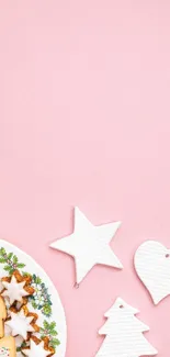 Festive pink wallpaper with cookies and white decorations.