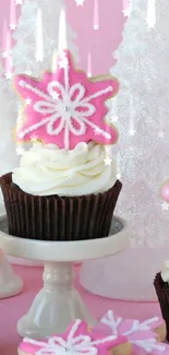 Pink cupcake with snowflake cookie on winter decor.