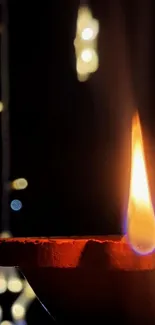 Festive diya and vibrant lantern glowing in dark setting.