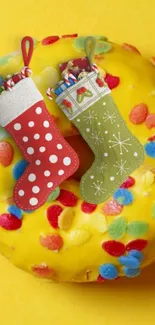 Festive donut with colorful sprinkles and holiday stockings on a vibrant background.