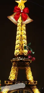 Eiffel Tower decorated with Christmas lights and a tree at night.