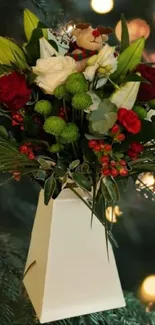 Festive bouquet of roses with greenery against glowing light backdrop.