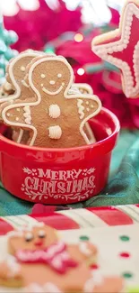 Festive gingerbread cookies in a Christmas-themed red bowl with holiday decor.