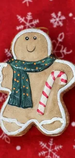 Gingerbread man with scarf on festive red background.