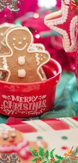 Gingerbread cookies in a red Christmas bowl with festive decor.