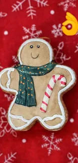 Gingerbread cookie with snowflakes on red holiday background.