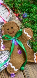 Gingerbread ornament with green ribbon on rustic wood background.