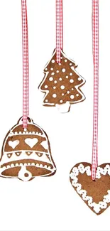 Festive gingerbread ornaments with hearts, bell, and tree shapes on ribbons.