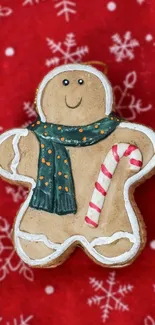 Festive gingerbread man with candy cane on red snowflake background.