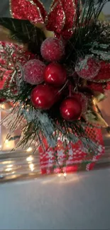 Festive glass gift box with red decorations and lights.