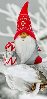 Gnome with red hat on snow-covered branch in winter wonderland.