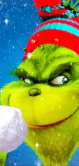 Festive Grinch holding snowball with winter background.