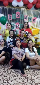 Group celebrating with colorful balloons and festive decoration.