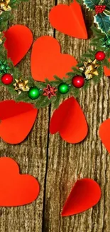 Festive wallpaper with red hearts and Christmas wreath on wood.