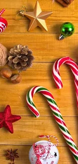 Holiday themed wallpaper with candy canes and festive ornaments on a wooden background.