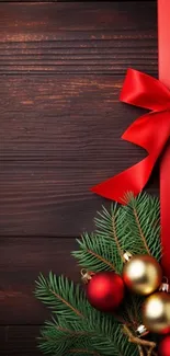 Festive wallpaper with red ribbon and ornaments on wooden background.