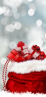 Red bag filled with gifts against a snowy background.