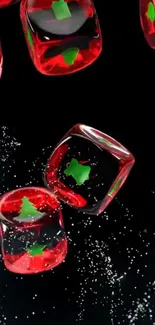 Red ice cubes with Christmas trees on black background.
