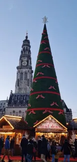 Christmas market scene with large tree and lights.