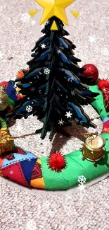 Mini Christmas tree with colorful ornaments on a festive wreath.