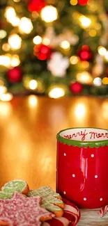 Red Christmas mug with cookies in festive setting.