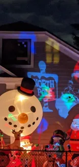 Festive night scene with snowmen and colorful lights on a house.