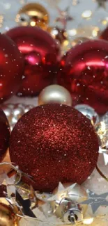 Vibrant red and gold Christmas ornaments creating a festive holiday scene.