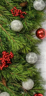 Festive pine branches with red berries and ornaments