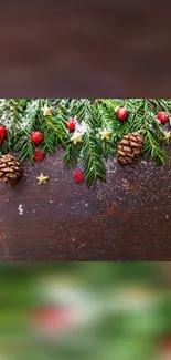 Festive pine garland with berries and snowy accents on a wooden background.