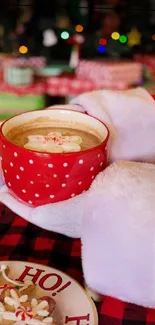 Santa's hands holding festive hot cocoa mug.