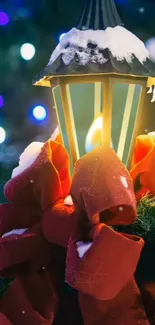 Snow-covered lantern with red bow in festive setting.