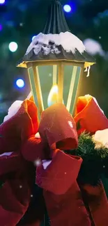 Snow-covered lantern with red ribbons and festive lights.