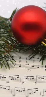 Festive wallpaper with red ornament and sheet music.