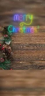 Neon Merry Christmas text on wooden background with festive decorations.