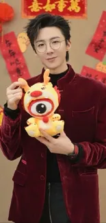 Person in maroon suit with festive toy and New Year decor.