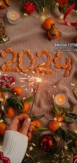 Festive 2024 New Year wallpaper with oranges, candles, and sparkler.