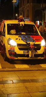 Colorful vehicle in a night street parade with festive decorations.