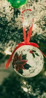 Christmas tree ornament with red ribbon and green background.