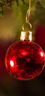 Festive red Christmas ornament hanging on a tree.