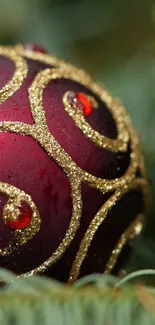 Red ornament with golden swirls, festive holiday wallpaper.